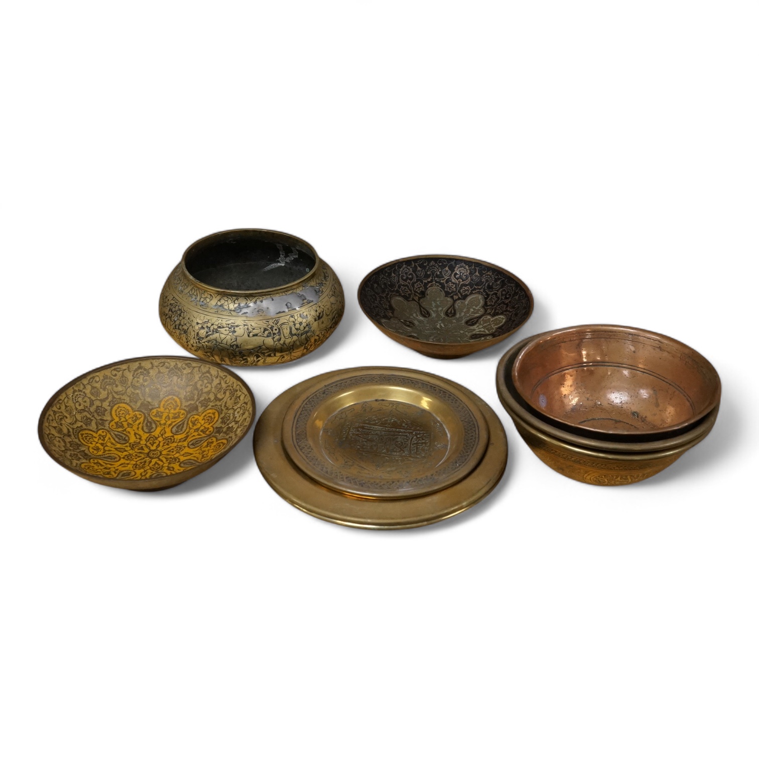 A group of Islamic and Indian brass bowls, largest 15cm in diameter
